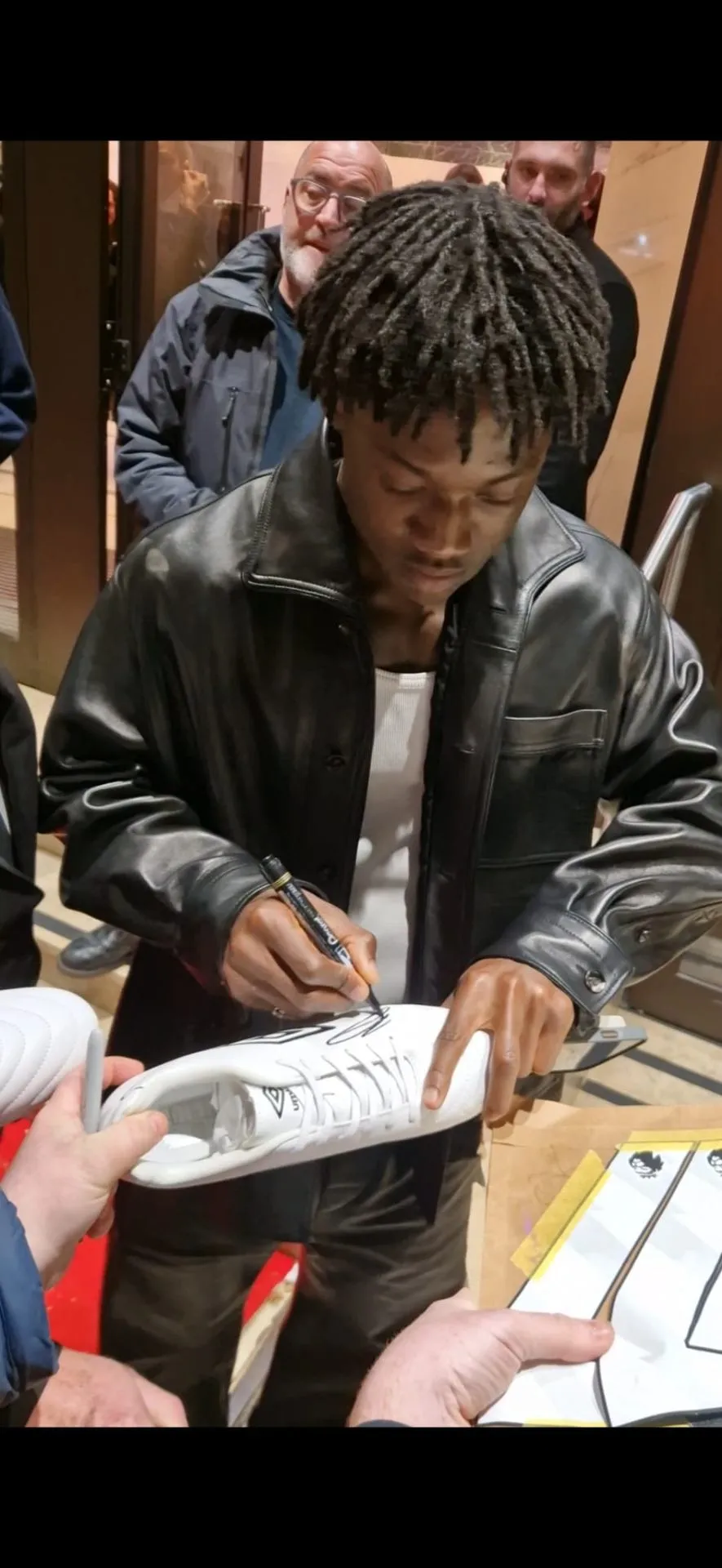 Footballer signing a boot