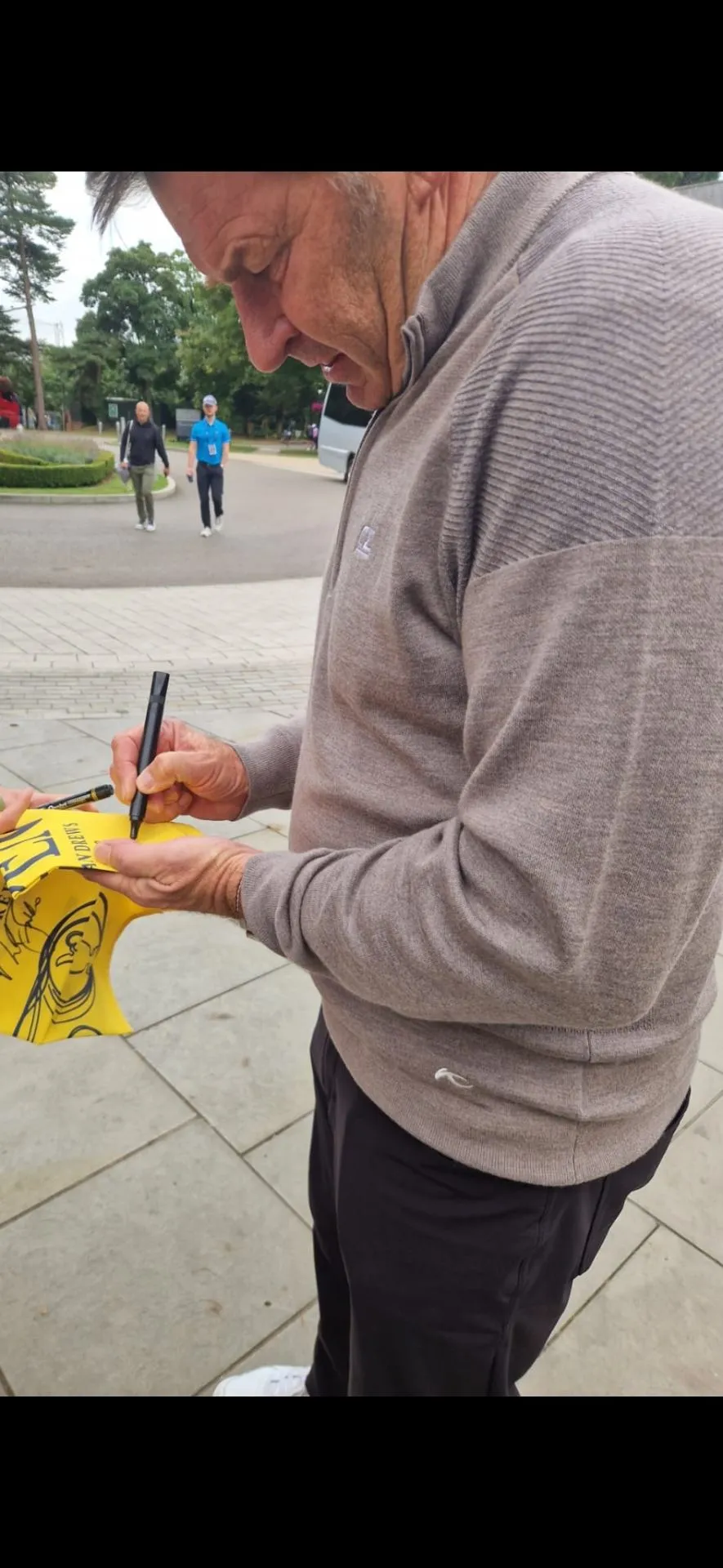 Golfer signing a pin flag