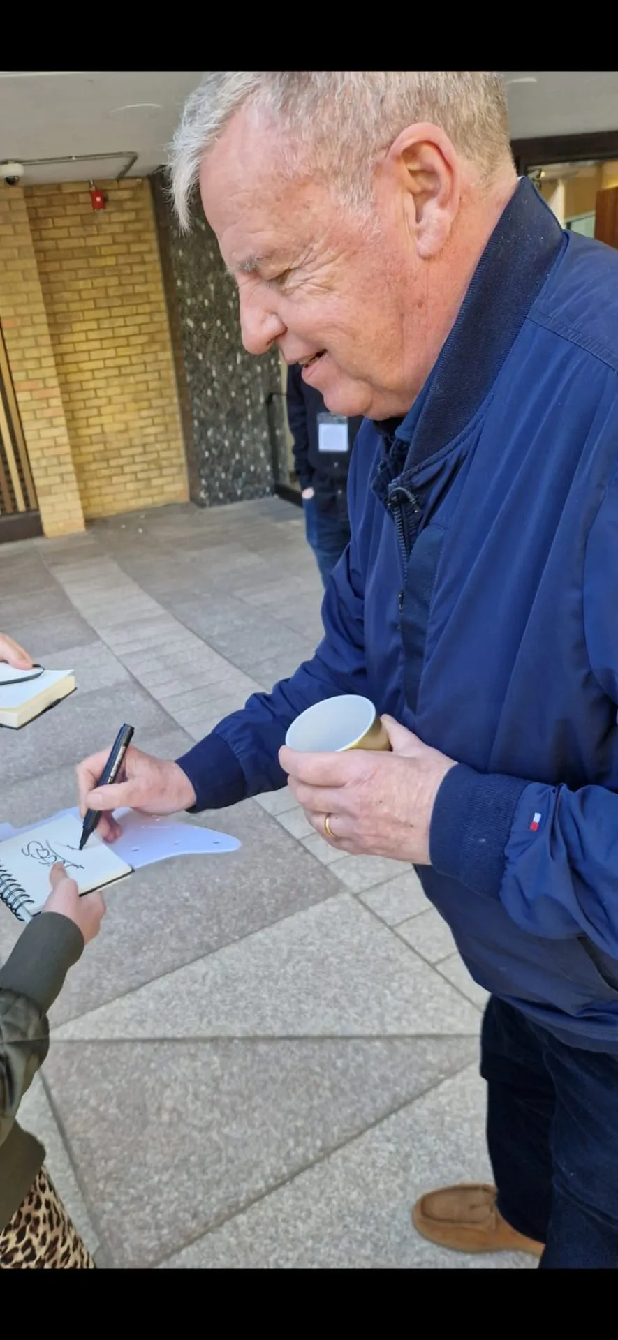 Celebrity signing autographs outdoors