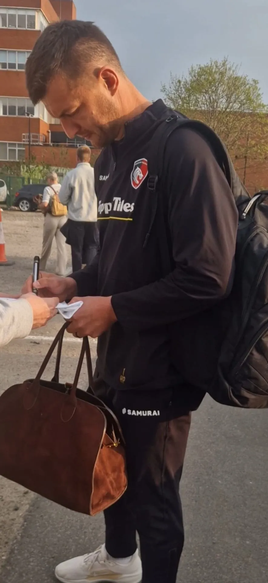 Rugby player signing for fans