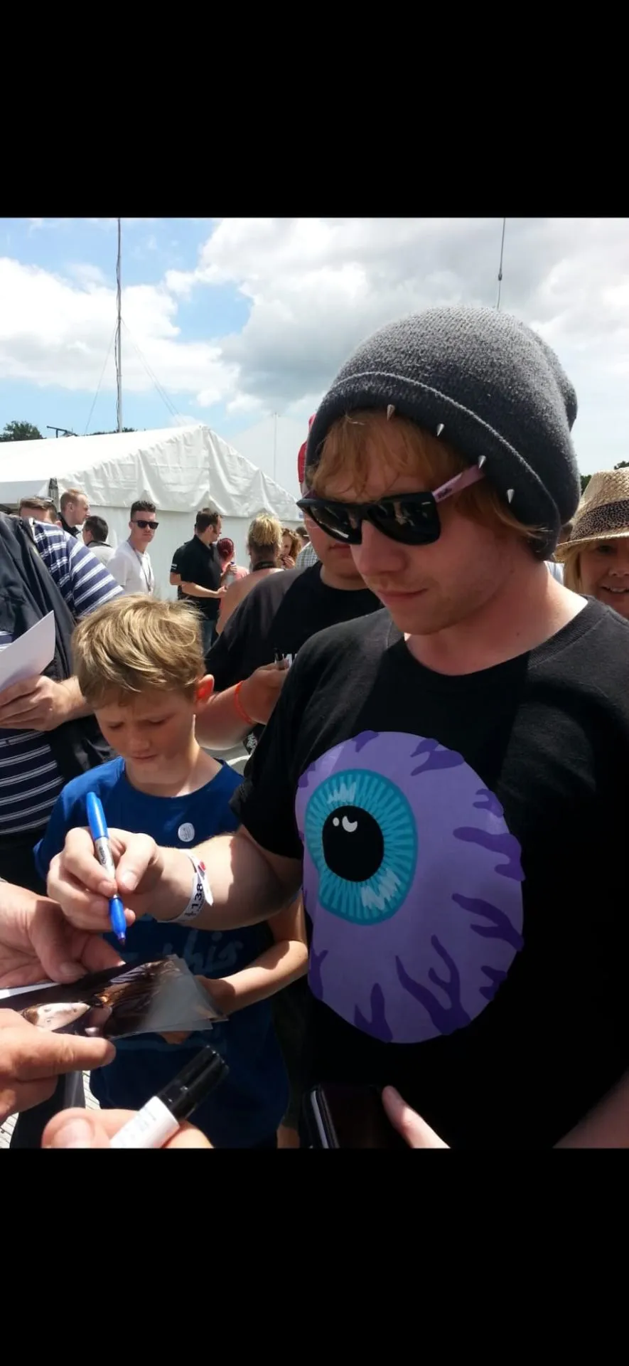 Actor signing autographs for fans