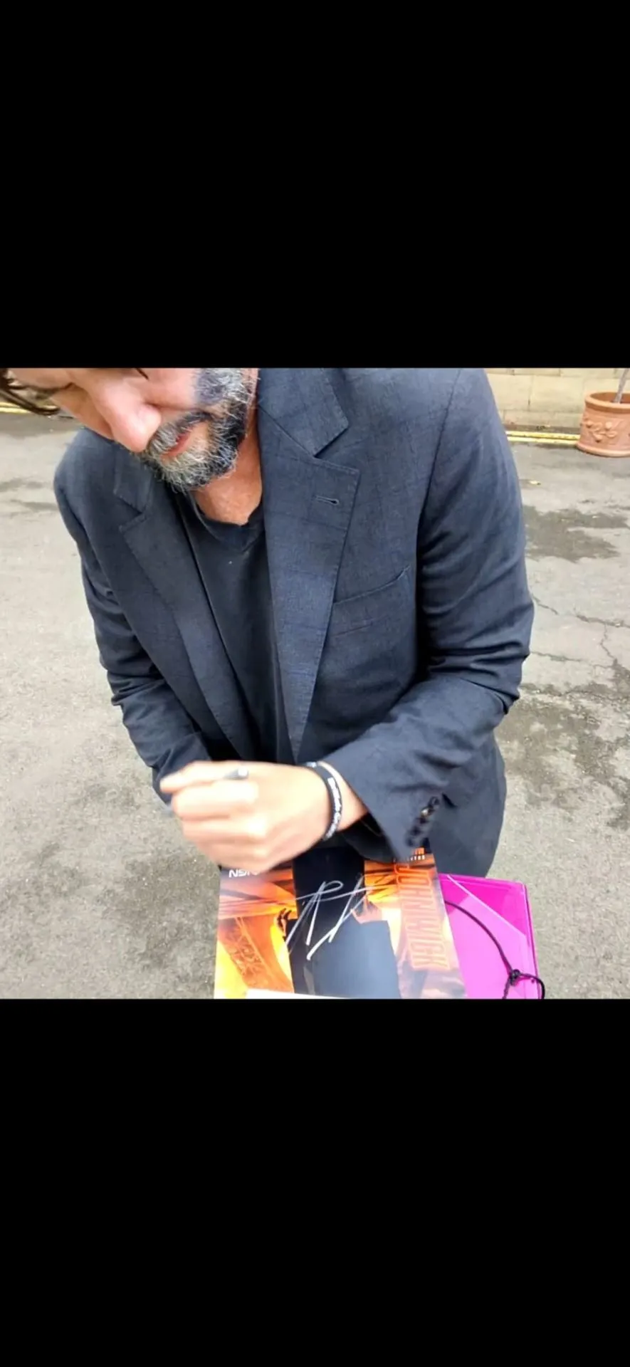 Celebrity signing a movie poster