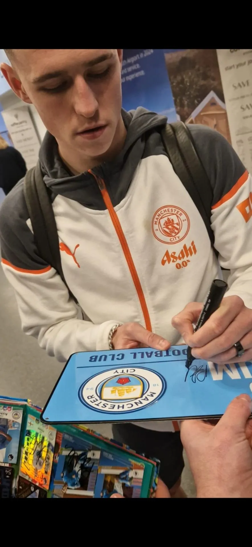 Footballer signing a Man City plaque