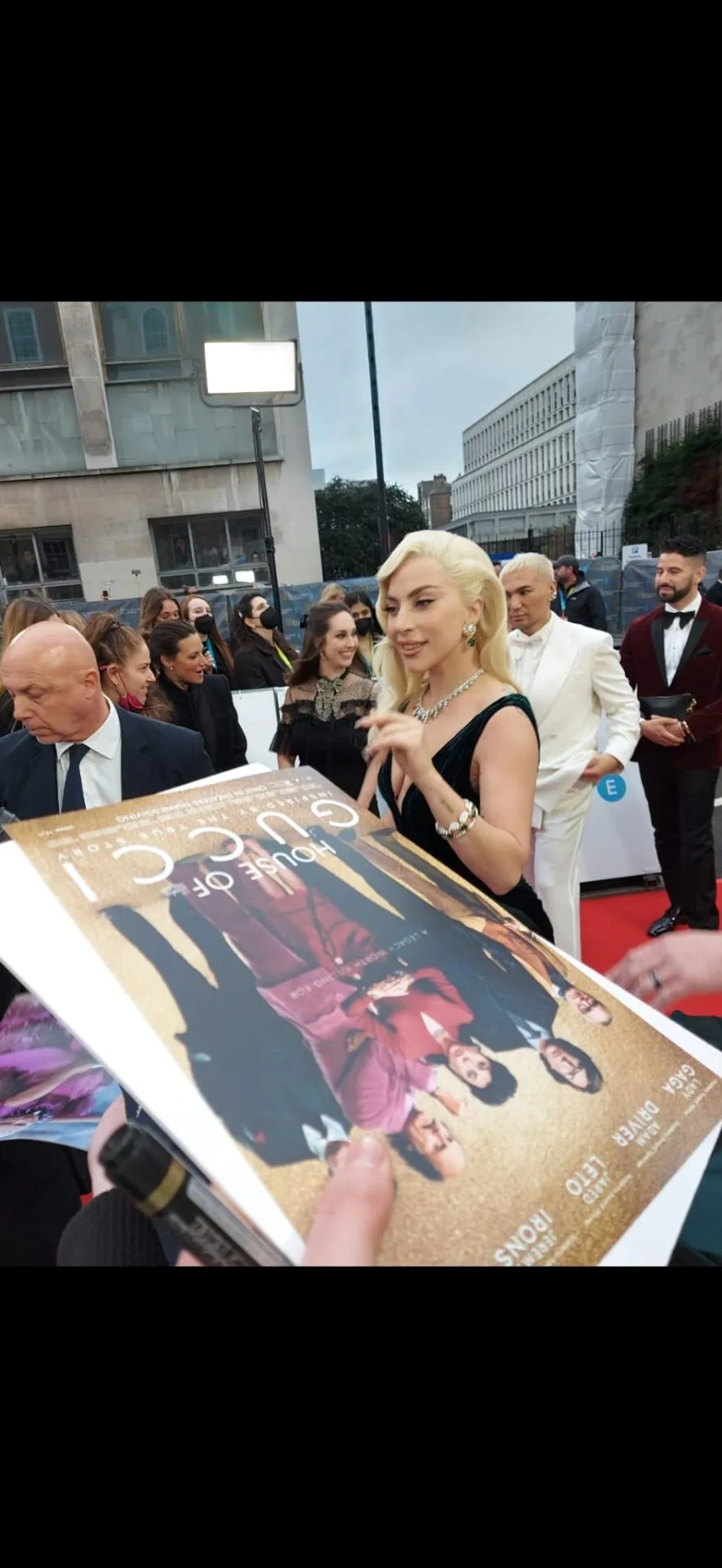 Lady Gaga signing a House of Gucci poster