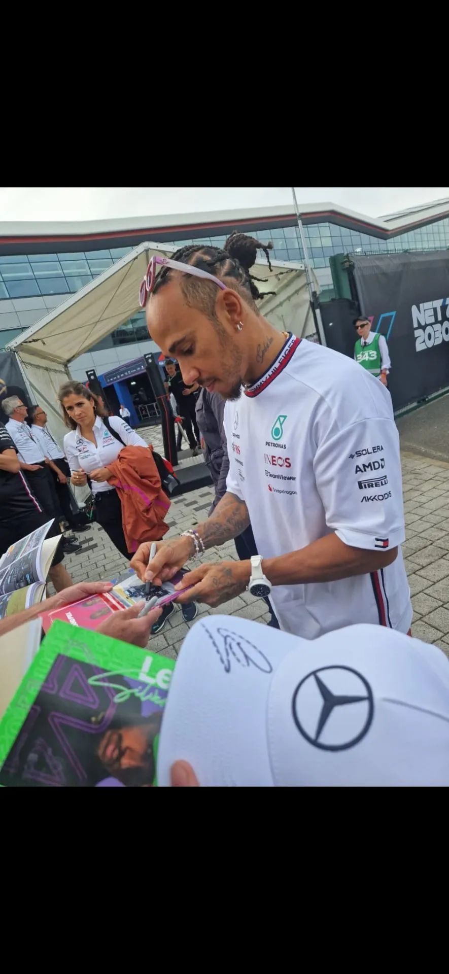 Lewis Hamilton signing autographs at the track